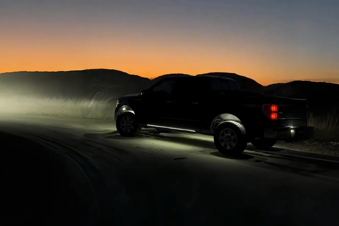 Off-road truck with rock lights in desert at sunset - universal accessories for trucks, Jeeps, ATVs and UTVs
